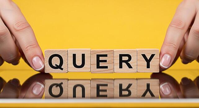 Elegant hands arranging wooden blocks spelling QUERY on a reflective surface against a vibrant yellow backdrop symbolizing information retrieval and the pursuit of knowledge with a modern clean aesthe photo