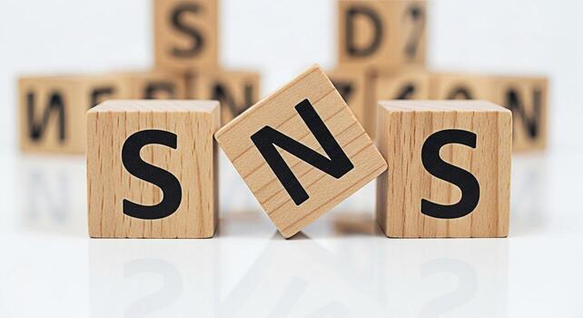 Wooden blocks spelling SNS on a white surface symbolizing social networking services with a focus on connection and communication in a digital environment conveying a modern and minimalist aesthetic photo