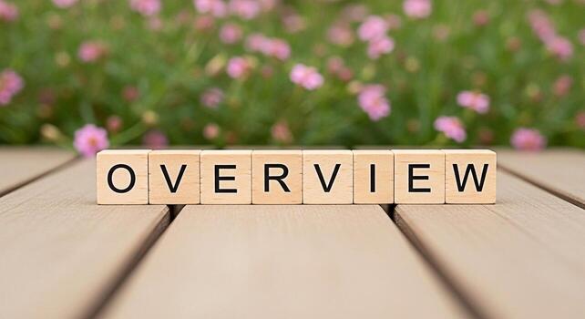 Wooden blocks spelling OVERVIEW arranged on a wooden surface in a garden setting providing a comprehensive summary and conveying a sense of clarity and understanding in a natural environment photo