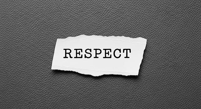 Rasgado papel mostrando el palabra el respeto en un texturizado gris antecedentes simbolizando el importancia de el respeto en sociedad y interpersonal relaciones Fomentando un cultura de comprensión y empatía foto