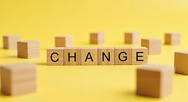Wooden blocks spelling CHANGE on a bright yellow background symbolizing transformation and adaptation in a dynamic business environment conveying a message of progress and positive evolution photo