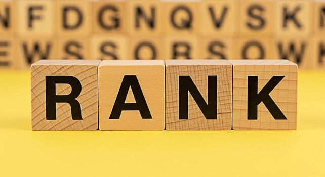 Wooden blocks displaying the word RANK on a bright yellow surface symbolizing achievement and success in a competitive environment conveying a sense of order and hierarchy in business and personal gro photo