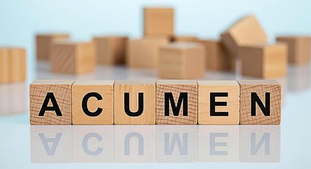 Wooden blocks spelling ACUMEN reflecting on a glossy surface symbolizing sharp insight and intelligence in a bright minimalist setting conveying a sense of clarity and focus for business success photo