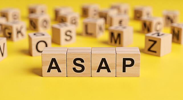 Wooden blocks spelling ASAP on a bright yellow background conveying urgency and the need for immediate action symbolizing efficiency time management and a proactive approach to tasks and deadlines in photo