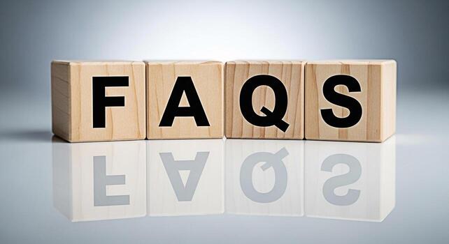 Wooden blocks spelling FAQs on a reflective surface in a brightly lit studio representing information access and customer support with a clean modern aesthetic and a focus on clarity and helpfulness photo