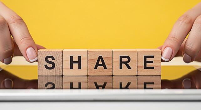 Female hands arranging wooden blocks spelling SHARE on a reflective surface against a vibrant yellow backdrop symbolizing connection collaboration and the importance of sharing information and resourc photo