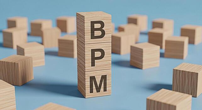 Wooden blocks displaying BPM on a blue surface representing Business Process Management with a focus on efficiency and optimization in a minimalist and clean environment conveying a sense of order and photo