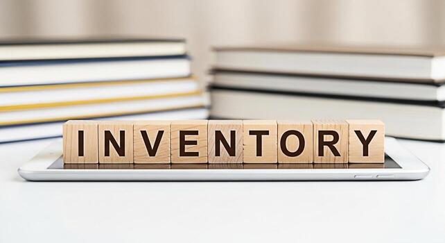 Wooden blocks spelling Inventory resting on a tablet in a bright studio setting symbolizing organization stock management and efficient business operations for retail and ecommerce photo