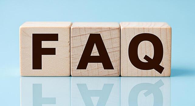 Wooden blocks spelling FAQ on a blue reflective surface representing frequently asked questions providing answers and creating a sense of clarity and understanding for customer support and information photo