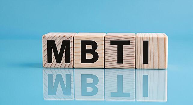 Wooden blocks displaying MBTI on a reflective blue surface used to represent personality assessment and psychological type in a clean modern environment conveying concepts of selfawareness and underst photo