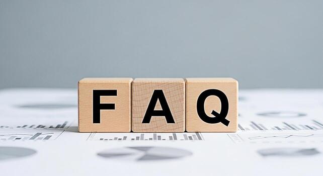 FAQ wooden blocks sitting on financial reports providing answers to common questions in a business setting conveying clarity and support for customers and stakeholders fostering trust and transparency photo