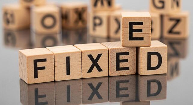 Wooden blocks spelling out the word FIXED on a reflective surface symbolizing problemsolving and resolution creating a sense of stability and reliability with a focus on solutions and positive outcome photo