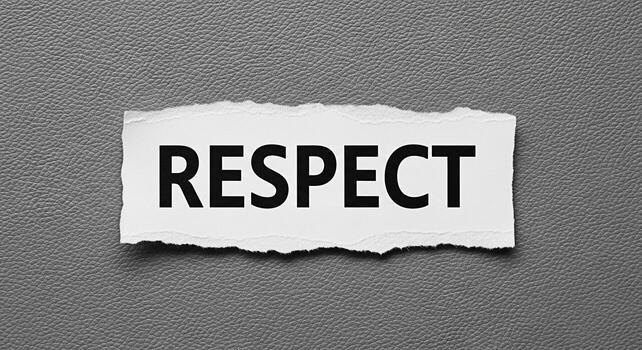 The word Respect displayed on a torn piece of paper placed on a textured gray surface symbolizing the importance of values and ethical behavior in personal and professional relationships photo