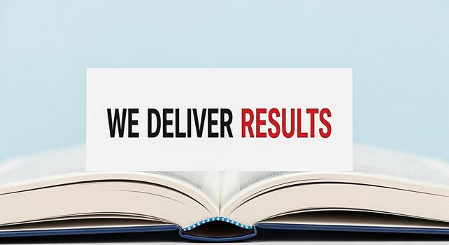 Open book displaying a card with the message We Deliver Results against a light blue background symbolizing success achievement and the power of knowledge to drive positive outcomes in business and pe photo