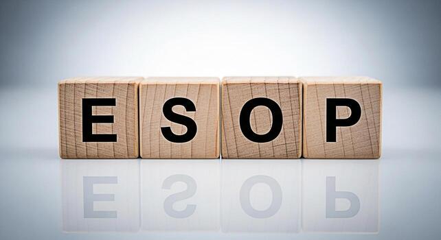 Wooden blocks spelling ESOP on a reflective surface symbolizing employee ownership and financial planning in a corporate setting conveying a message of empowerment and shared success photo
