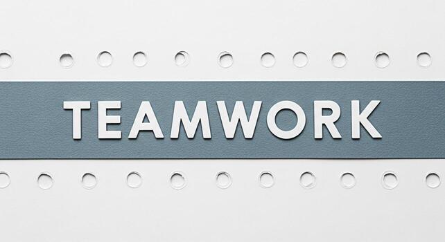 The word Teamwork displayed in white letters on a gray banner against a white background with evenly spaced holes symbolizing collaboration unity and the importance of working together effectively photo