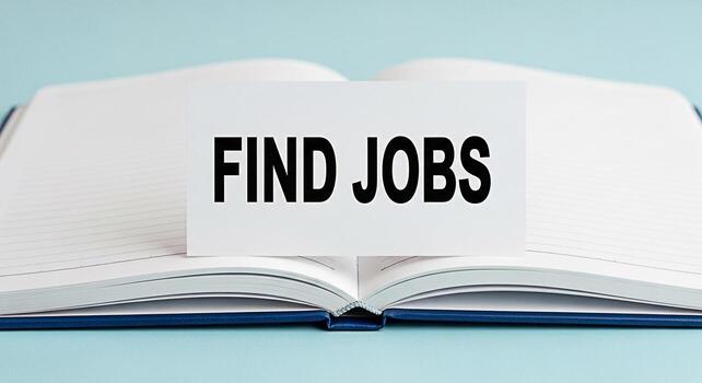 Open notebook displaying a Find Jobs card on a light blue surface symbolizing career opportunities and job searching creating a hopeful and proactive atmosphere for employment seekers photo