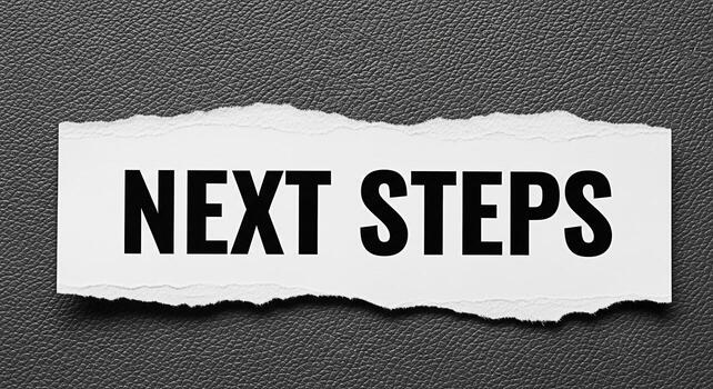 Boldly displayed Next Steps message on a torn piece of paper against a textured gray background symbolizing progress forward movement and a clear path towards achieving goals with determination and fo photo