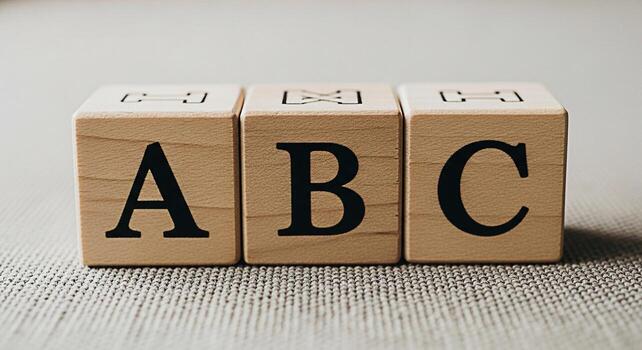 Closeup of wooden alphabet blocks displaying ABC on a textured surface symbolizing early childhood education learning the basics and a playful approach to language development in a bright and inviting photo