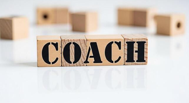 Wooden blocks spelling COACH on a reflective white surface symbolizing guidance and mentorship creating a supportive and motivational atmosphere for personal and professional development photo