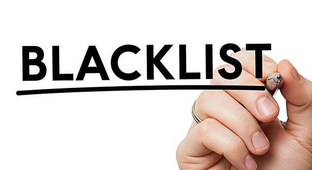 Closeup of a hand underlining the word Blacklist on a white background symbolizing restriction and exclusion creating a stark and decisive visual statement about limitations and consequences photo
