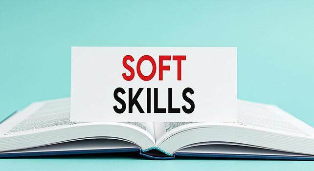 Open book displaying a card with the words Soft Skills in red and black on a light blue background representing the importance of interpersonal skills and emotional intelligence in personal and profes photo