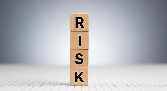 Wooden blocks spelling RISK stacked on a white grid surface symbolizing potential challenges and opportunities in business and investment creating a sense of calculated uncertainty and strategic decis photo