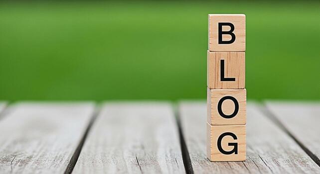 Wooden blocks spelling out BLOG on a rustic wooden table against a vibrant green background representing the concept of online content creation communication and the importance of blogging in the digi photo
