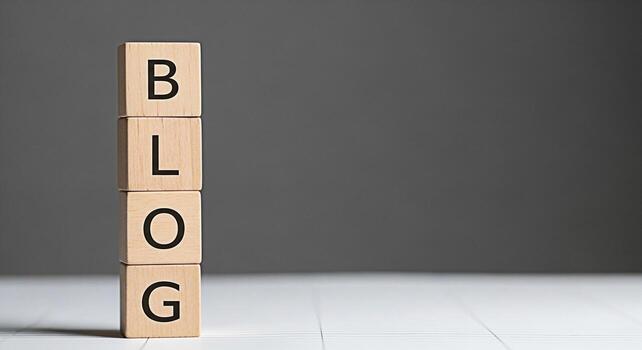 Wooden blocks stacked vertically displaying the word BLOG on a white surface against a gray backdrop representing online content creation digital marketing and the importance of blogging for business photo