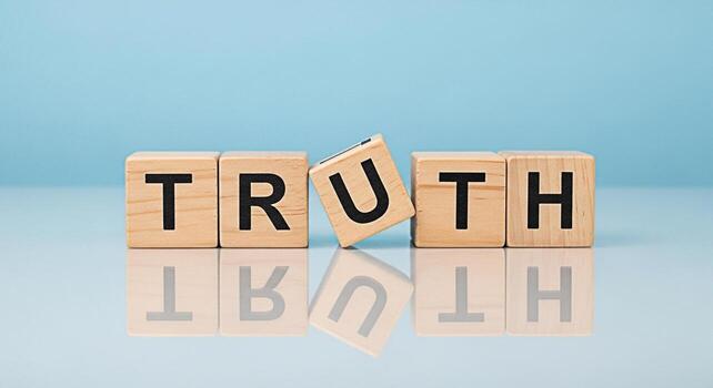 Wooden blocks spelling TRUTH on a reflective surface with one block slightly tilted conveying a message of honesty and integrity in a clean minimalist setting against a soft blue background promoting photo