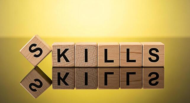 Wooden blocks spelling SKILLS on a reflective surface against a yellow background representing the importance of developing new skills and continuous learning for career advancement and personal growt photo