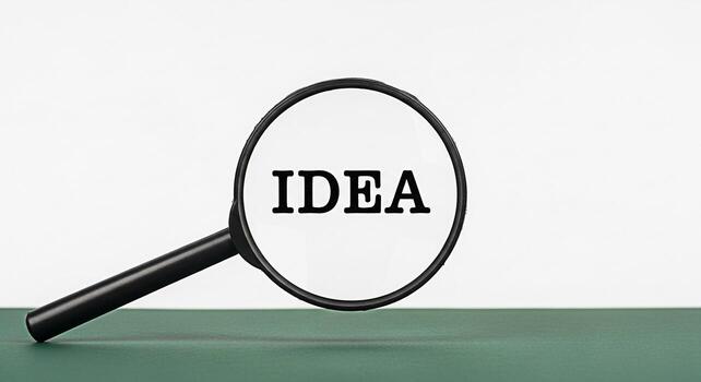 Magnifying glass focusing on the word IDEA on a green surface symbolizing discovery and insight representing the concept of innovation creativity and problemsolving in a clean and minimalist setting photo