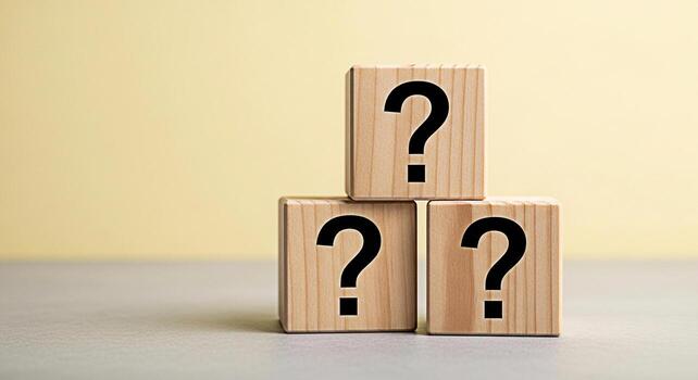 Stacked wooden blocks displaying question marks on a neutral surface symbolizing uncertainty and problemsolving in a minimalist and thoughtprovoking composition against a soft light background photo