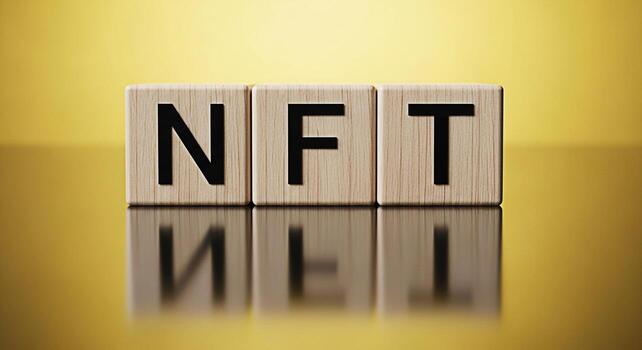 NFT letters displayed on wooden blocks against a golden background representing the concept of nonfungible tokens and digital assets in the modern cryptocurrency and blockchain technology era conveyin photo