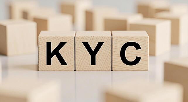 Wooden blocks displaying KYC on a reflective surface symbolizing compliance and identity verification in a financial setting conveying trust and security for banking and regulatory processes photo