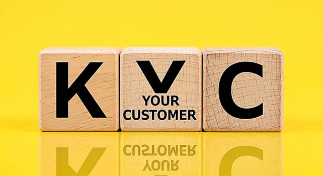 Wooden blocks displaying KYC - Know Your Customer on a bright yellow background representing compliance and identity verification in a financial and regulatory environment emphasizing trust and securi photo