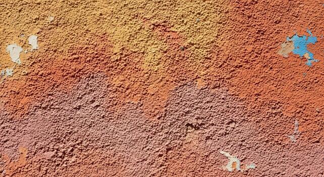 Textured wall with various colors, showing rough surfaces and peeling paint, creating an abstract and visually interesting background pattern photo