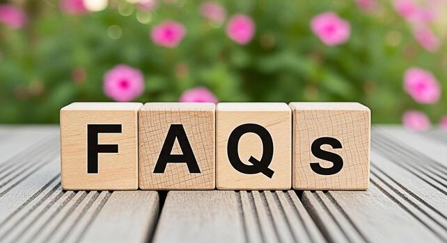 Wooden blocks spelling FAQs on a wooden surface in a garden setting conveying a sense of clarity and support perfect for customer service information resources and online help content creating a welco photo
