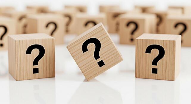 Wooden cubes displaying question marks on a reflective white surface symbolizing uncertainty and the search for answers in a clean minimalist setting evoking curiosity and problemsolving photo