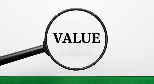 Magnifying glass focusing on the word Value against a clean white background with a green base symbolizing the importance of assessment and highlighting the concept of worth and significance in busine photo