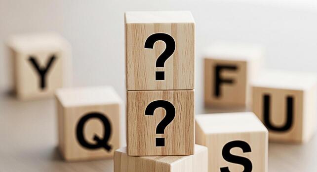 Stacked wooden blocks displaying question marks in a bright studio setting symbolizing uncertainty inquiry and the search for answers in business education and personal development contexts photo