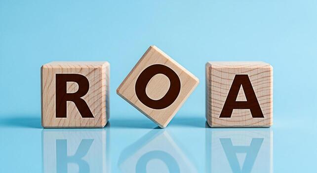 Wooden blocks displaying ROA on a blue reflective surface symbolizing Return on Assets in a clean and modern setting representing financial performance and investment analysis with a focus on profitab photo