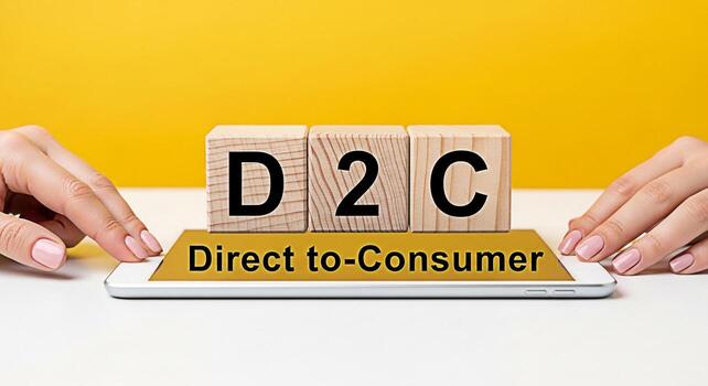 Elegant hands presenting D2C concept with wooden blocks and smartphone on a vibrant yellow background symbolizing modern directtoconsumer business strategies and innovative retail approaches for succe photo
