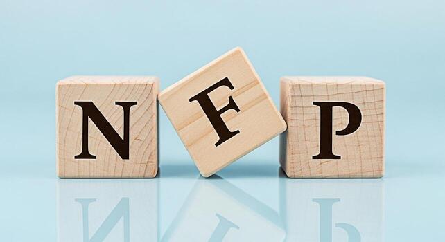 de madera bloques mostrando pfn en un reflexivo superficie en contra un ligero azul fondo representando no agrícola nóminas datos y económico indicadores simbolizando financiero análisis y mercado tendencias con un cl foto