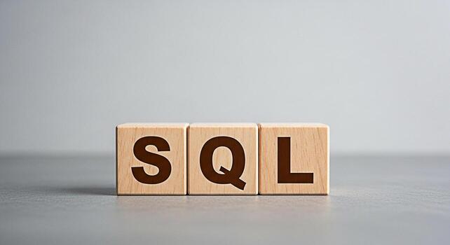Three wooden blocks displaying SQL on a gray surface representing database management and data querying in a clean minimalist setting conveying a sense of structured information and efficient data han photo