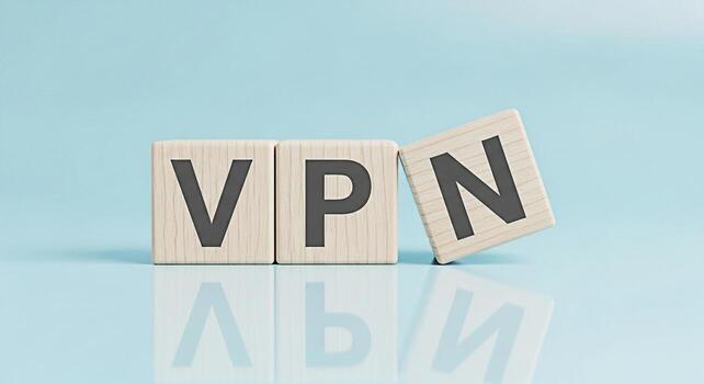 Wooden blocks spelling VPN on a reflective surface against a light blue background symbolizing secure internet access and data encryption for online privacy and cybersecurity solutions conveying trust photo