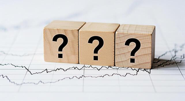 Three wooden blocks displaying question marks resting on a financial chart symbolizing uncertainty in the stock market and the need for strategic investment decisions in a volatile economic environmen photo