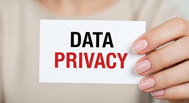 Closeup of a manicured hand holding a card that reads Data Privacy in a neutral setting emphasizing the importance of digital security and personal information protection in the modern age photo