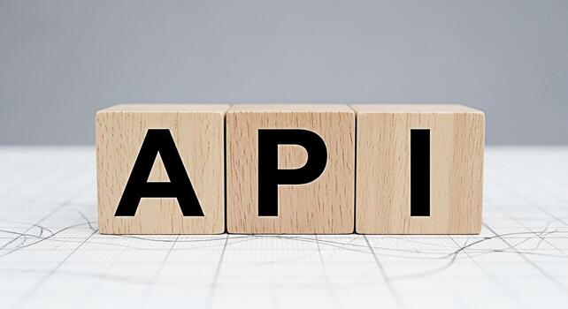 de madera bloques mostrando api acrónimo en un blanco cuadrícula superficie representando solicitud programación interfaz en un limpiar y minimalista ambiente simbolizando moderno tecnología y software desarrollo foto