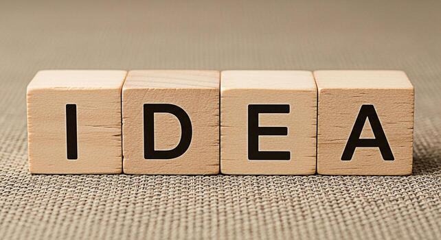 Wooden blocks spelling IDEA on a textured surface representing creative thinking and problemsolving in a simple conceptual arrangement symbolizing innovation and new perspectives for business and pers photo